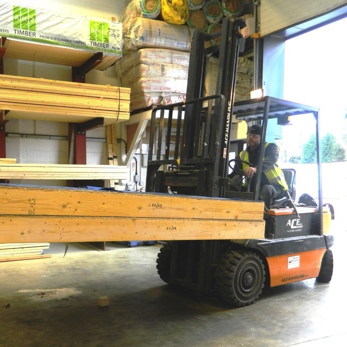 forklift carrying a timber frame